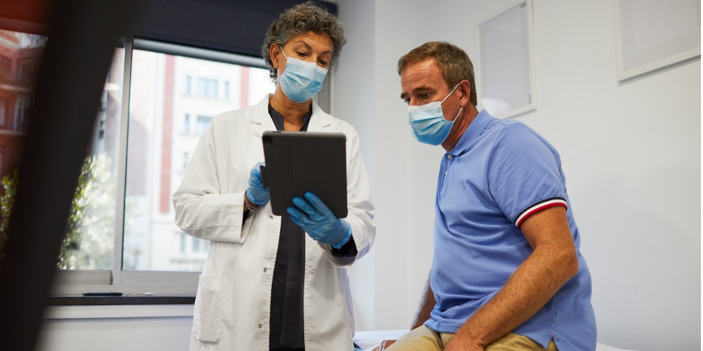 A doctor sharing medical results with a male patient during a medical research study