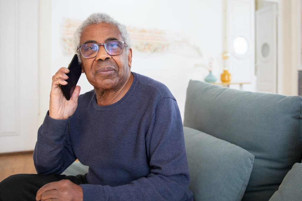A middle-aged male on the phone calling to learn more about paid medical studies