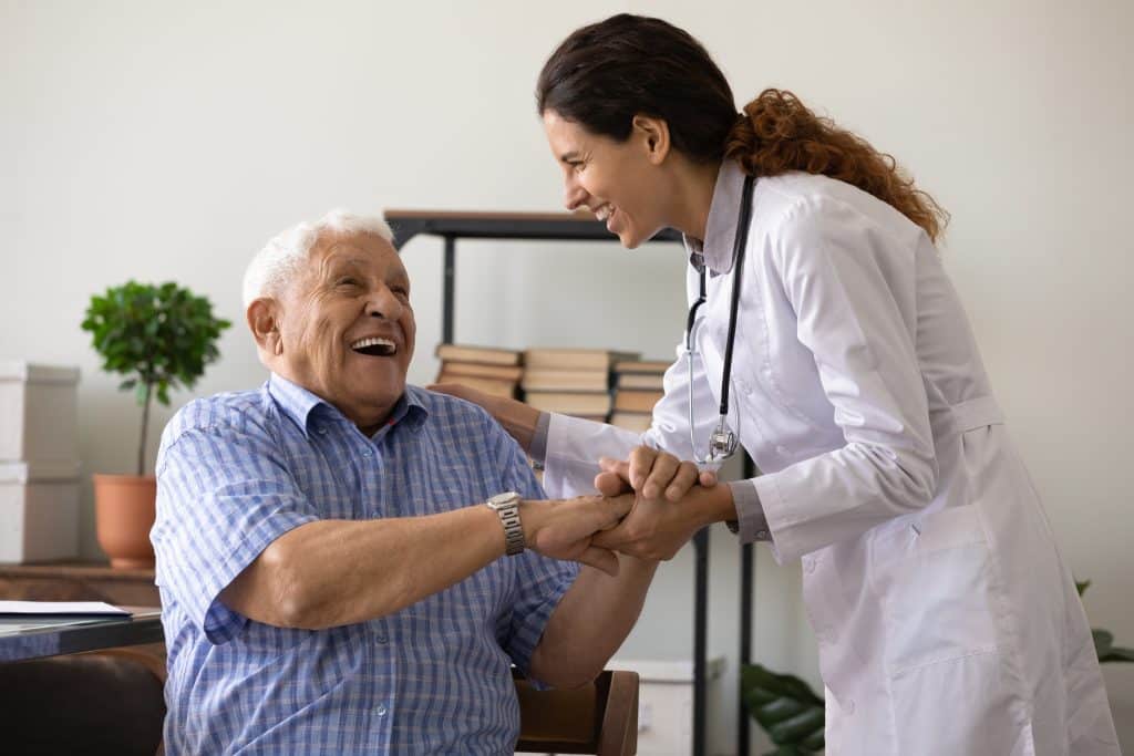 A caregiver helping an elderly patient during a paid research study